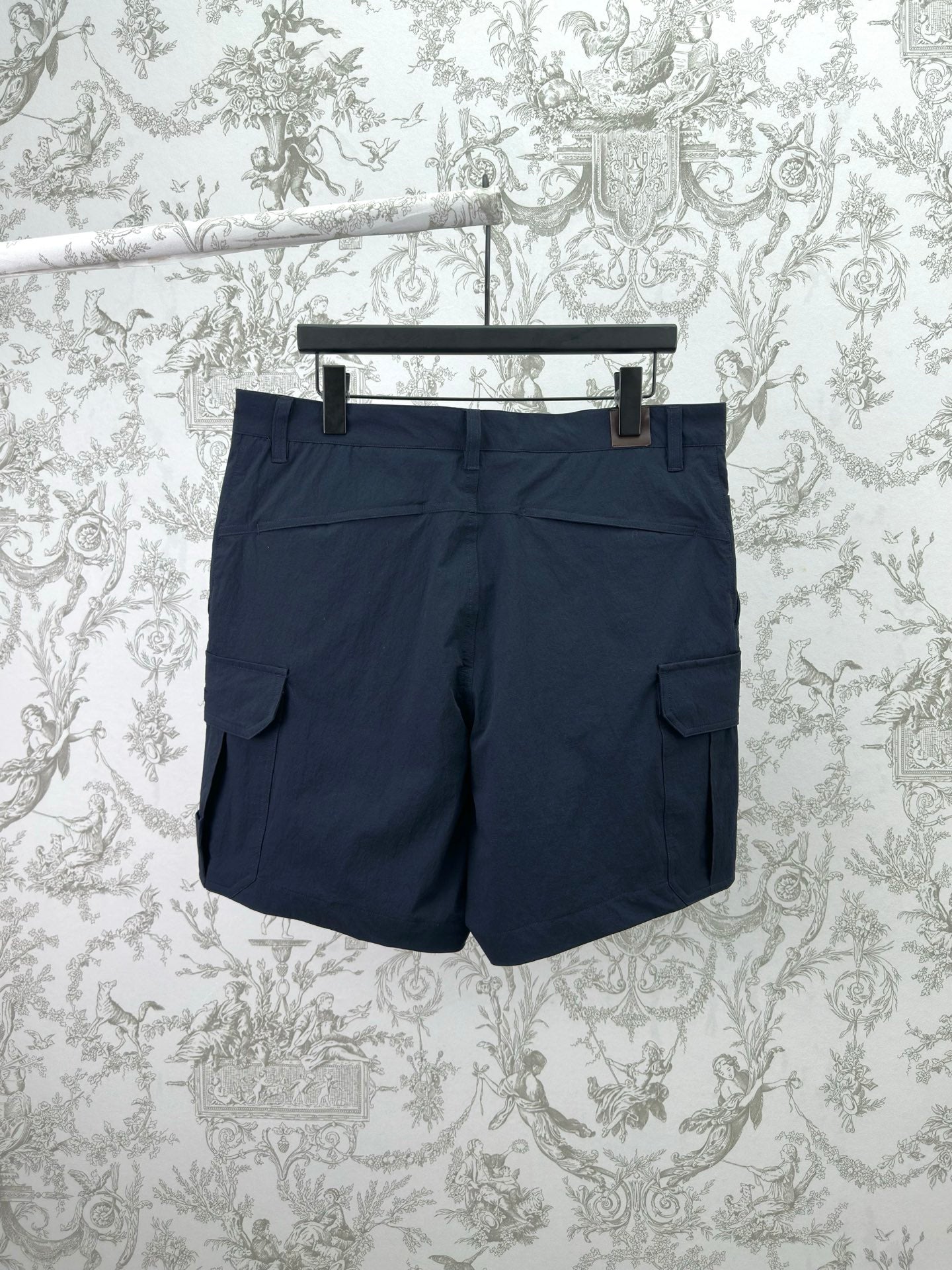 Dior navy shorts-style pants with cargo pockets and buttoned waistband