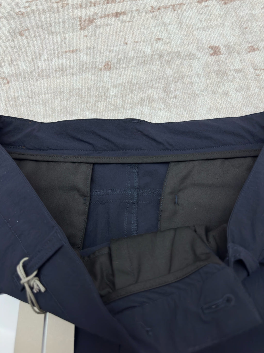 Dior navy pants showing interior waistband and pocket opening