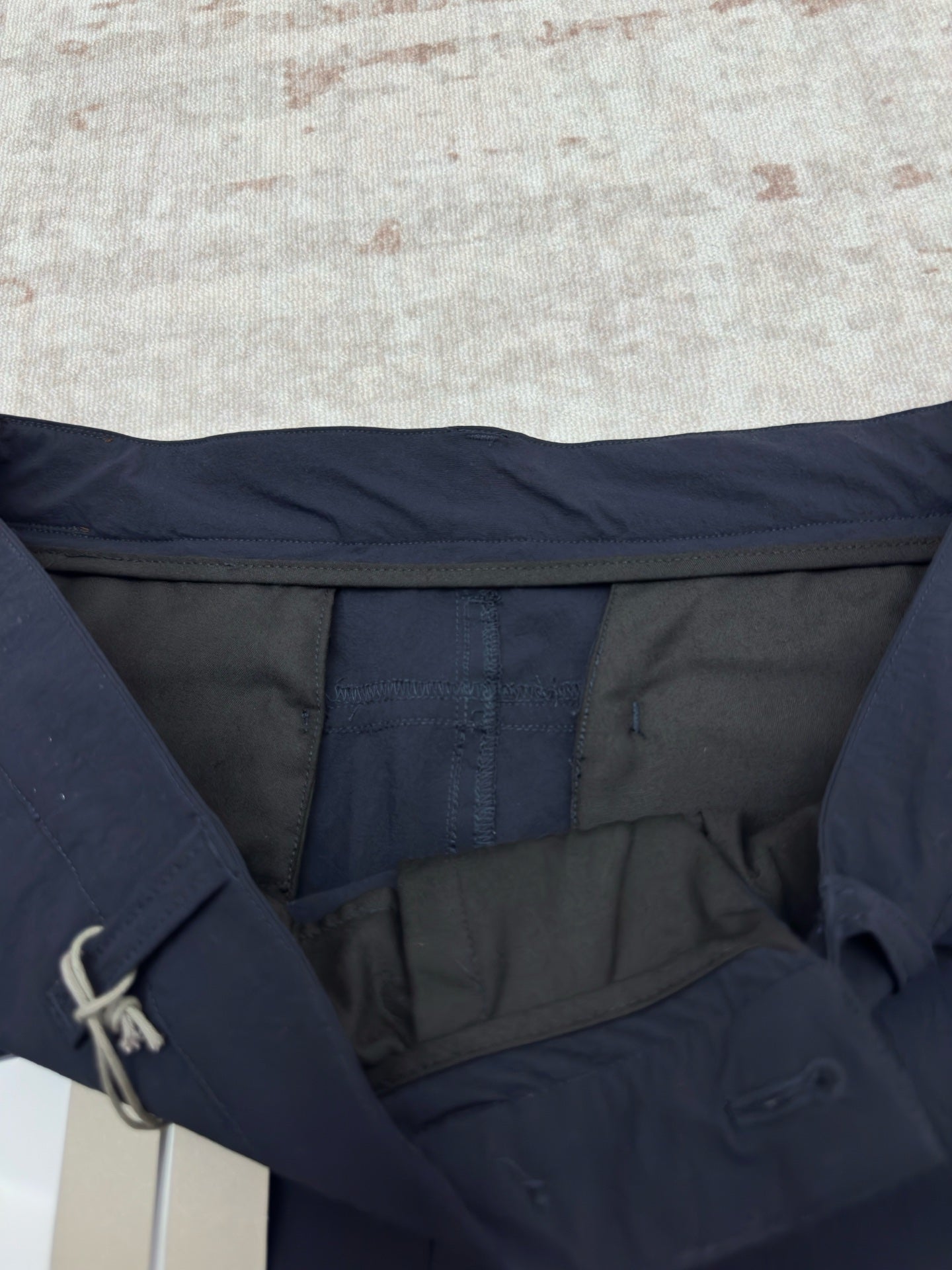 Dior navy pants showing interior waistband and pocket opening