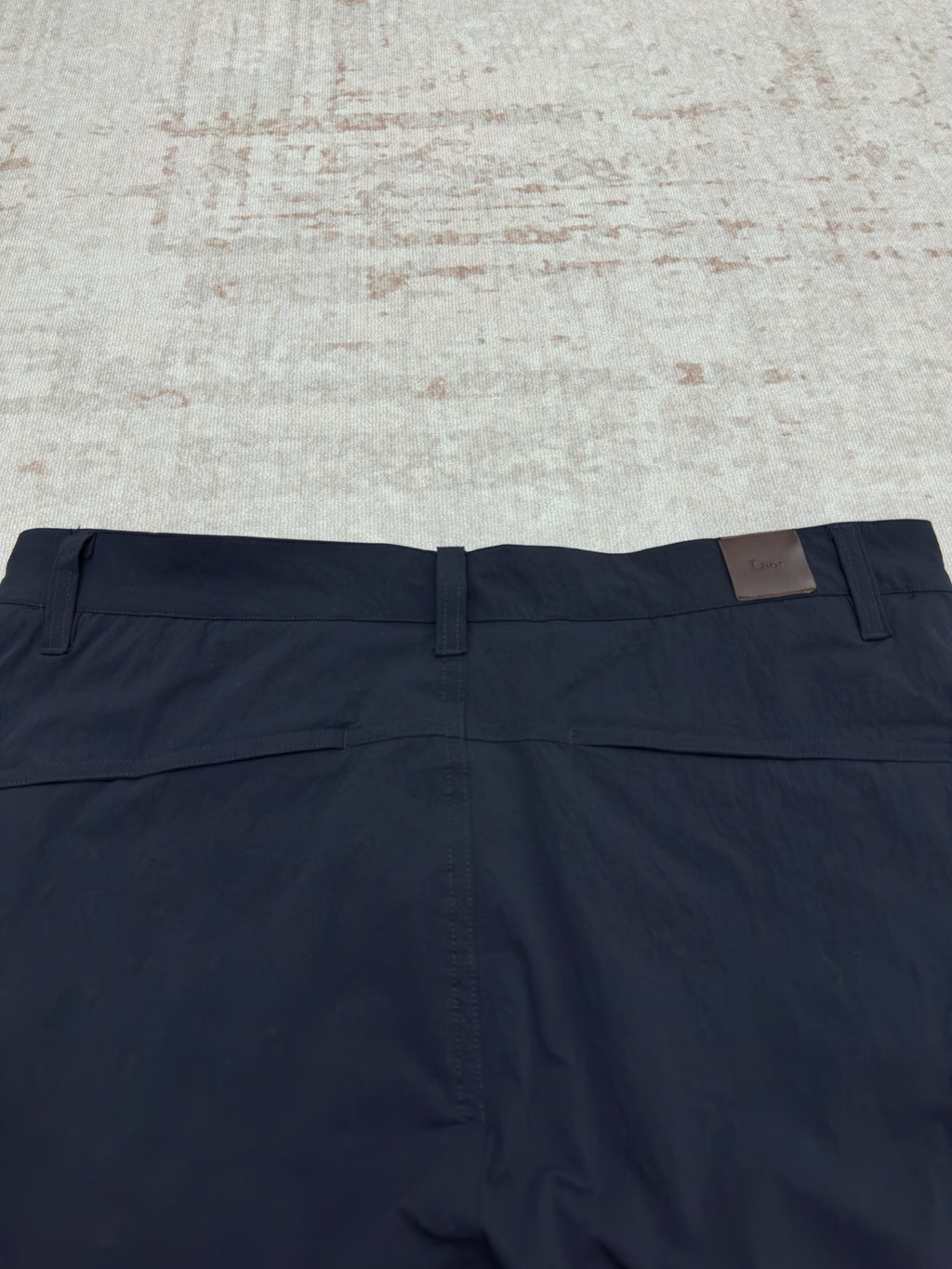 Dior navy pants with front fly, belt loops, and flat waistband