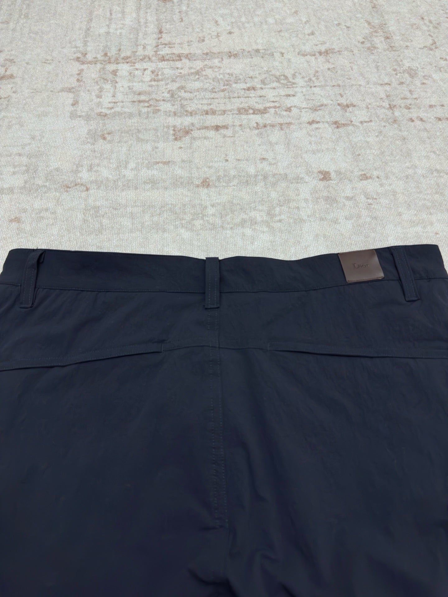 Dior navy pants with front fly, belt loops, and flat waistband