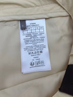 Light yellow shorts care label with size and fabric composition details
