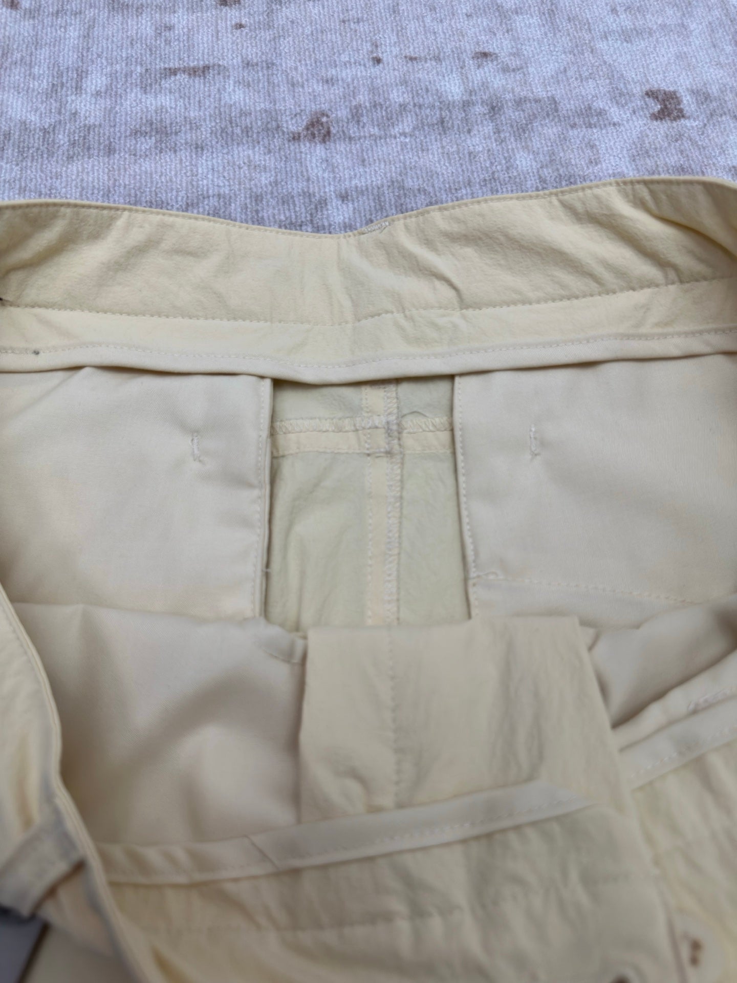 Light yellow shorts with inner waistband panel and center pocket detail