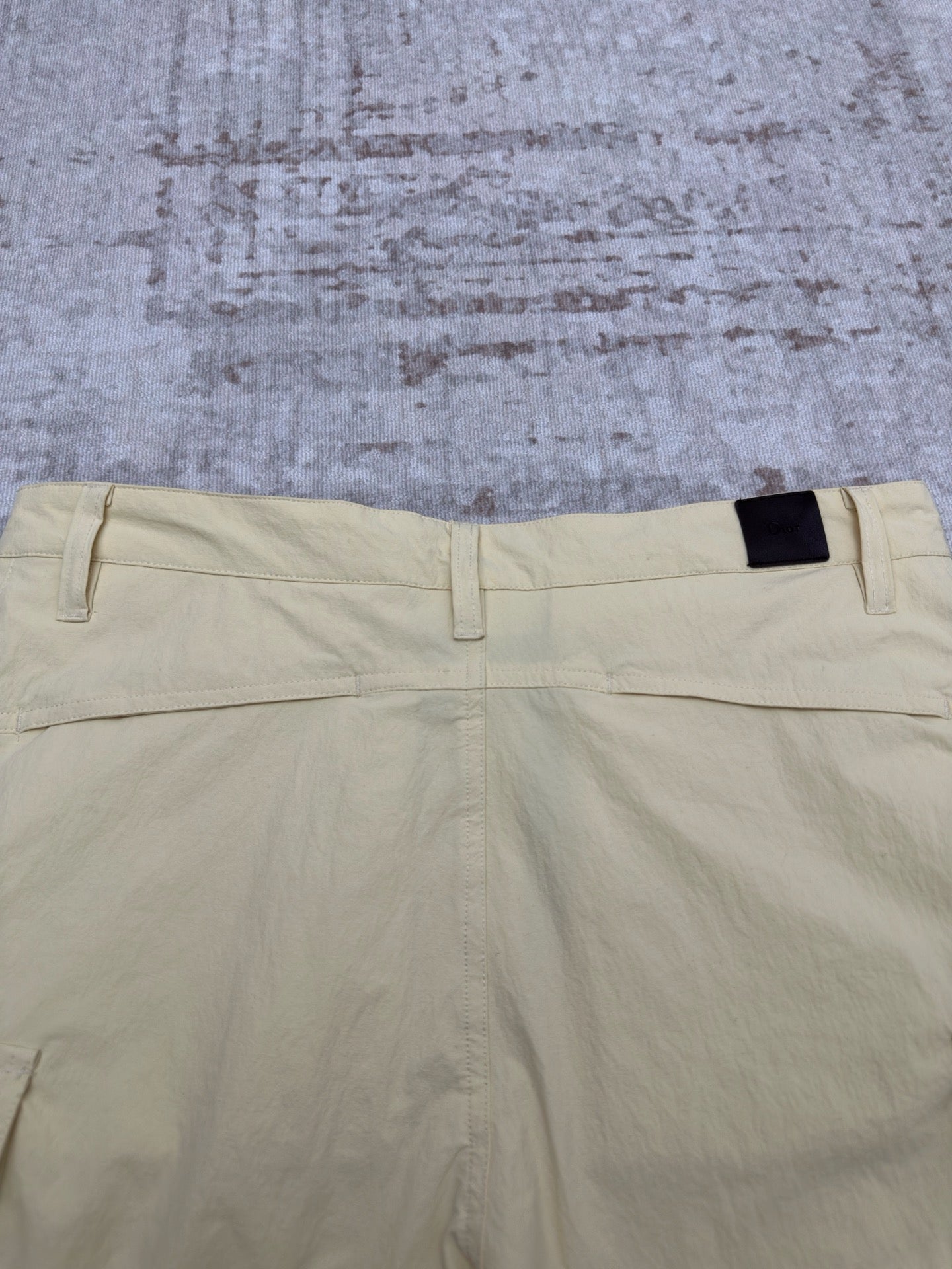Light yellow shorts back view with waistband tab and belt loops