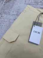 Light yellow shorts with cargo pocket and hanging Dior retail tag