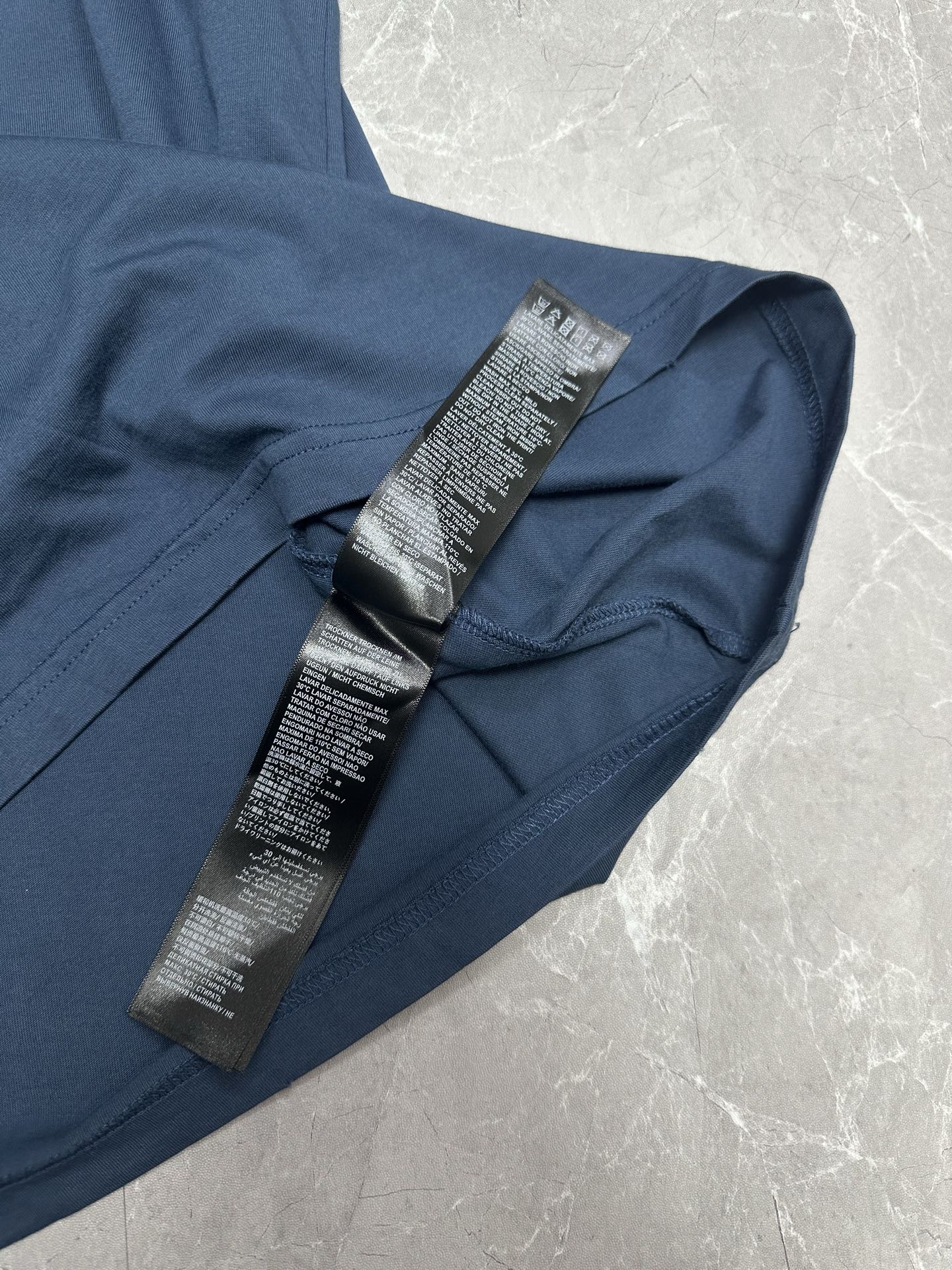 Balenciaga short-sleeve T-shirt detail showing care labels on inside collar