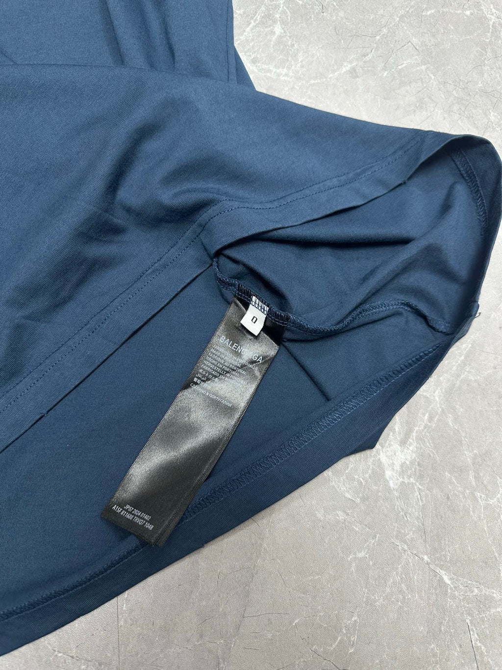 Balenciaga short-sleeve T-shirt sleeve close-up with care label at inner neck