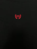 Black short-sleeve T-shirt with centered red crest logo