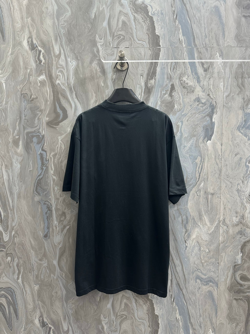 Black short-sleeve T-shirt on hanger, plain back view