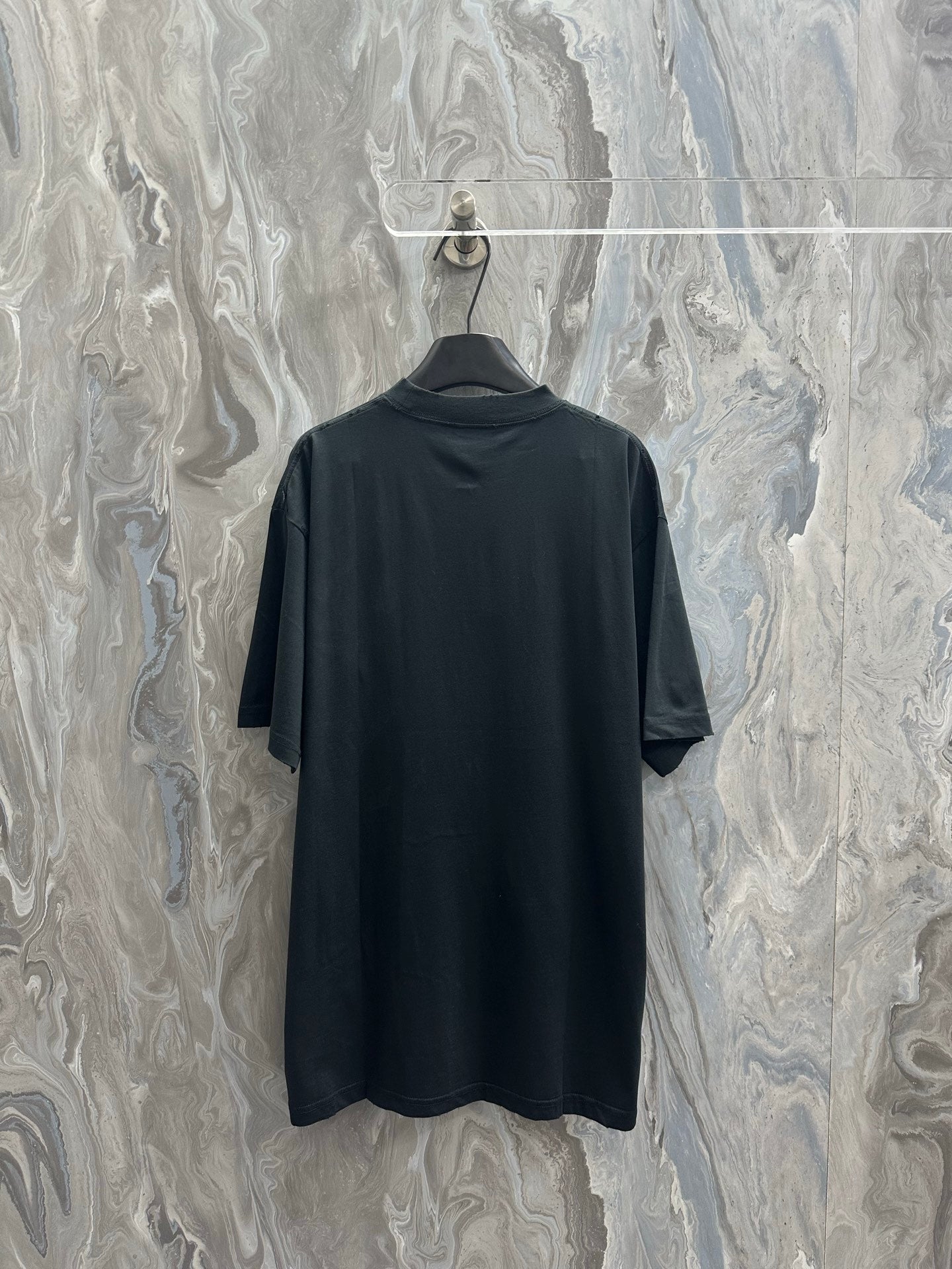 Black short-sleeve T-shirt on hanger, plain back view
