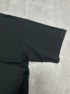 Black short-sleeve T-shirt sleeve and side seam close-up