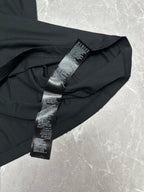 Black short-sleeve T-shirt with folded sleeve care label