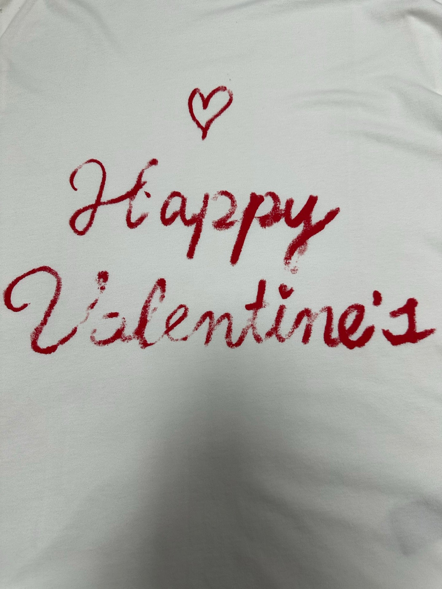 White T-shirt close-up of red “Happy Valentine’s” lettering