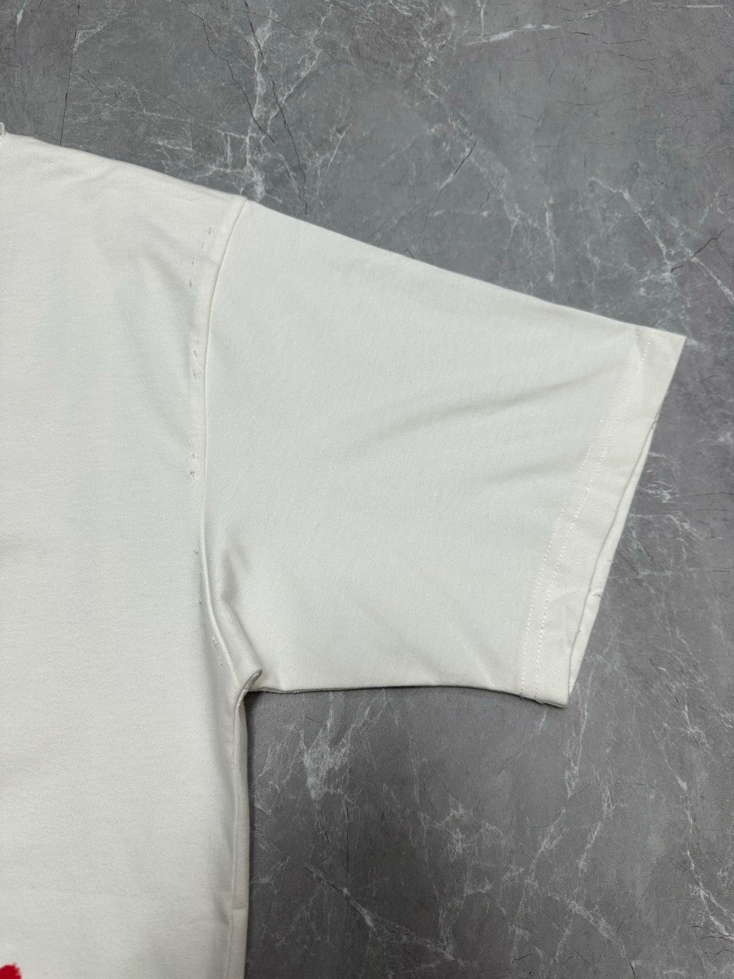 White T-shirt sleeve and side hem detail