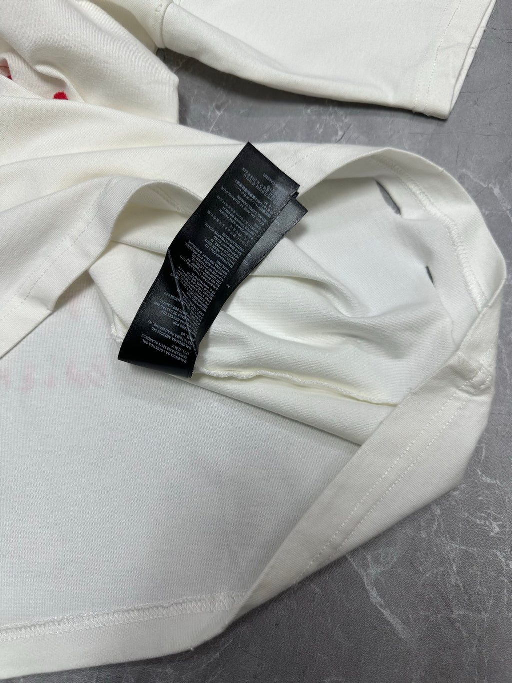 White T-shirt with black size label near crew neck seam