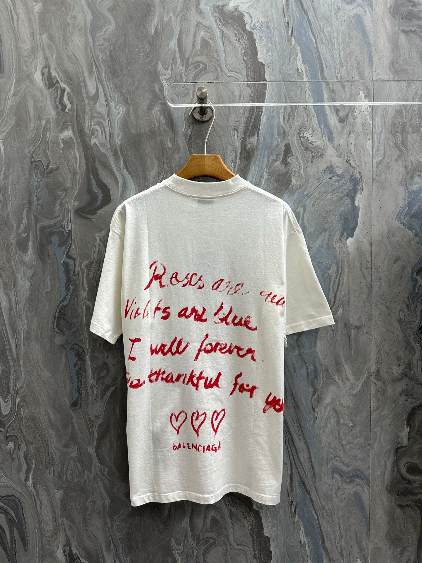 White short-sleeve T-shirt with red script text on back