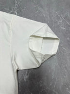 White T-shirt back corner with curved seam detail at hem