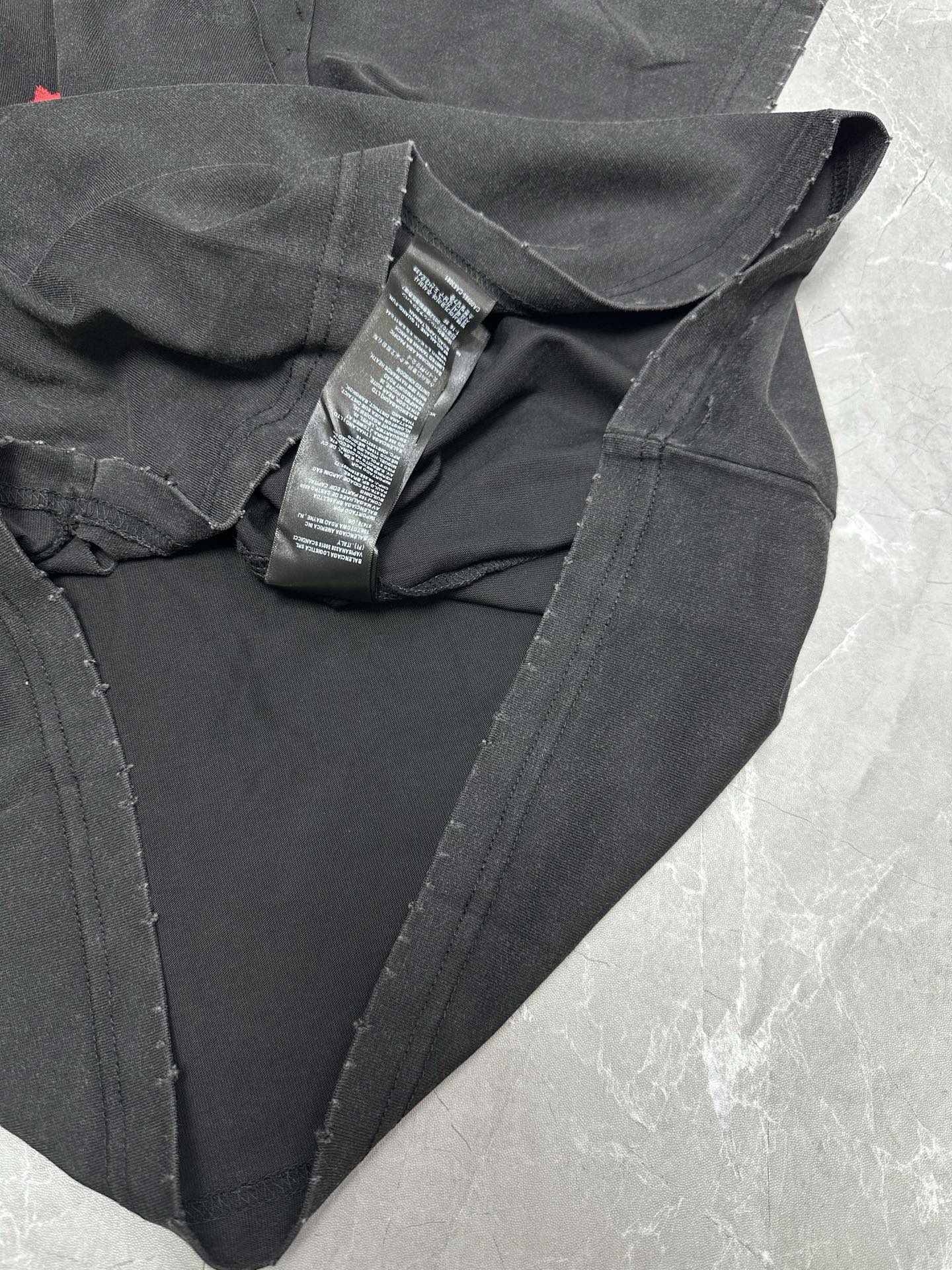 Black T-shirt with V-neck and folded collar label tags