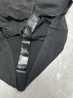 Black T-shirt with V-neck and brand tag labels near collar