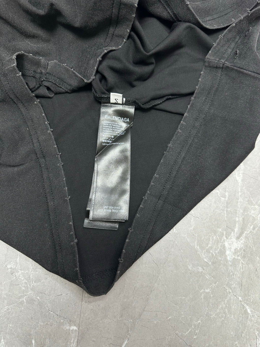Black T-shirt with V-neck and attached neck label tags
