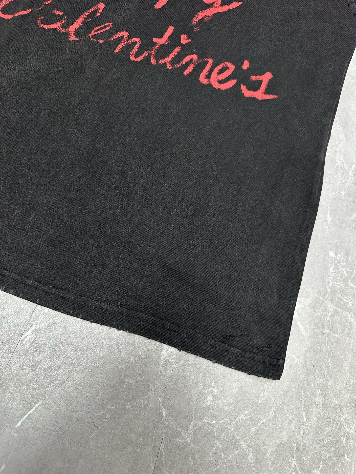 Dark gray short-sleeve T-shirt, partial red script lettering and straight hem