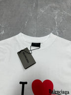 Balenciaga white short-sleeve T-shirt close-up with red heart graphic and neck tag