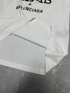 Balenciaga white short-sleeve T-shirt laid flat with graphic and curved hem