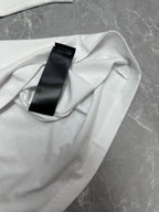 Balenciaga white short-sleeve T-shirt, care label tag close-up on fabric