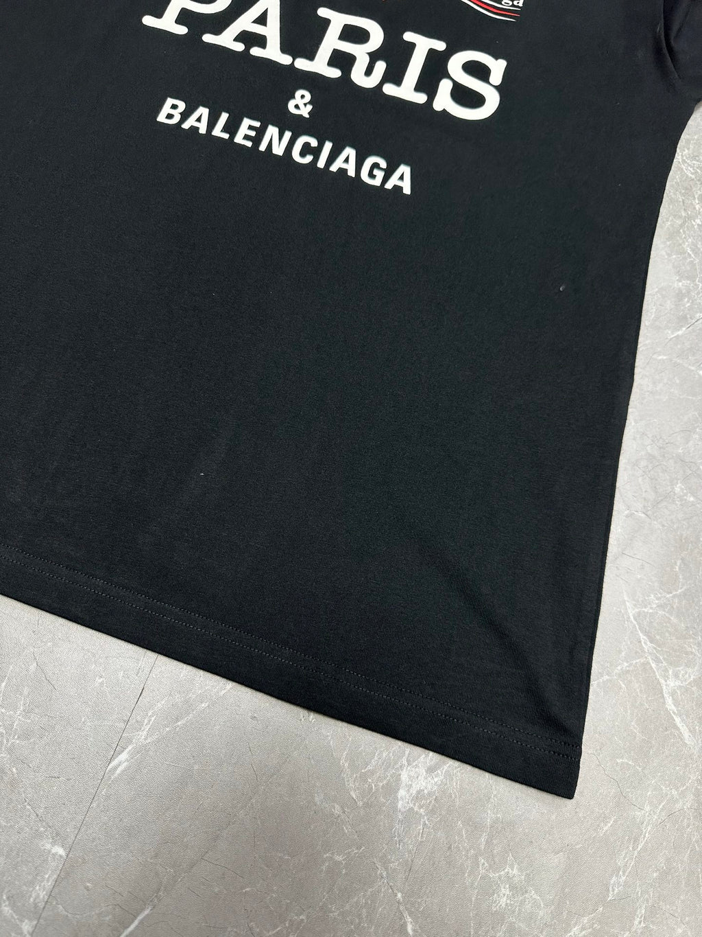 Black short-sleeve T-shirt with white 'PARIS & BALENCIAGA' text at hem.