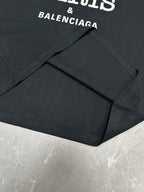 Black short-sleeve T-shirt with visible seams and BALENCIAGA logo text.