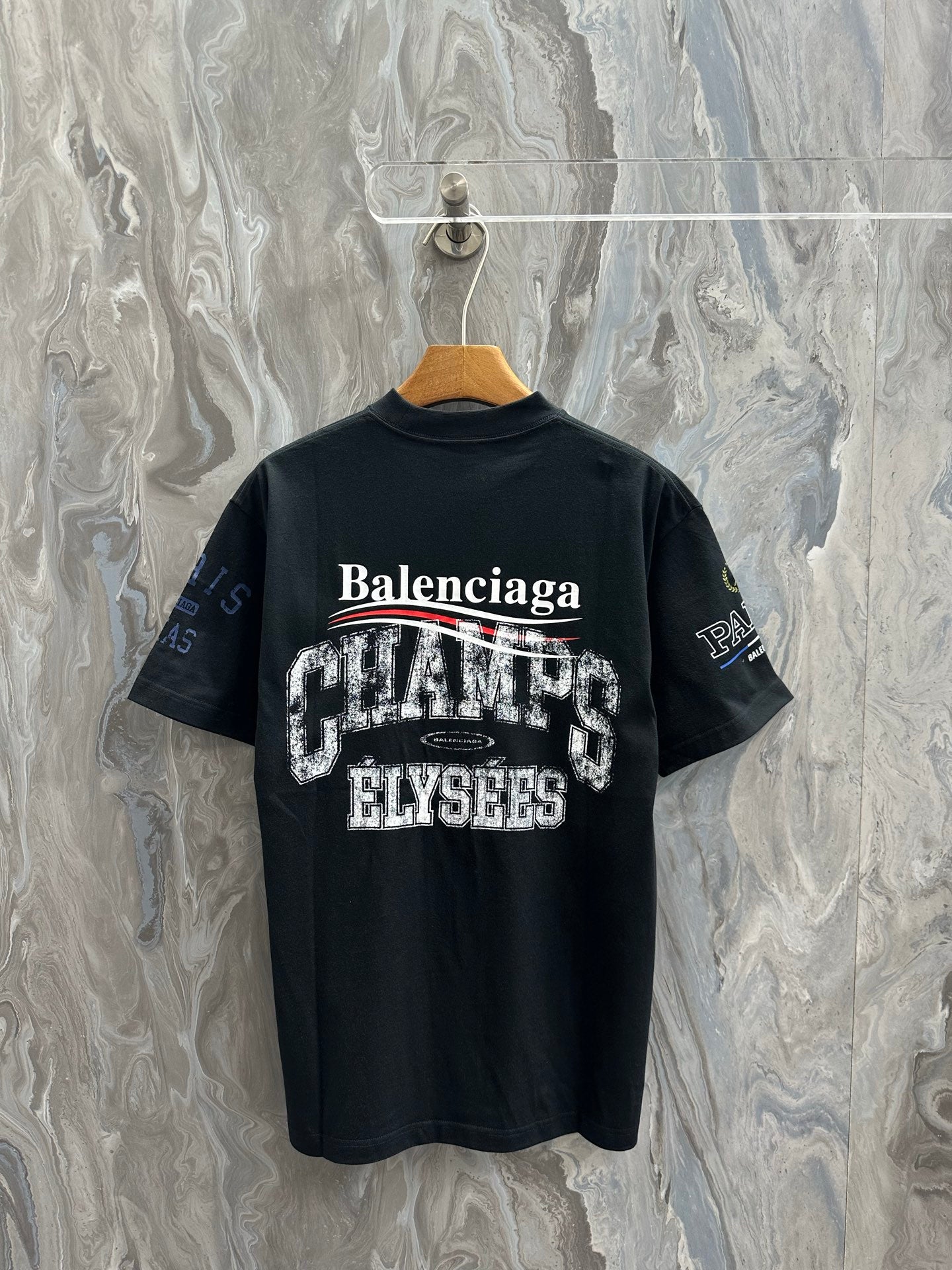 Black short-sleeve T-shirt with Balenciaga back print and 'CREATES' text.