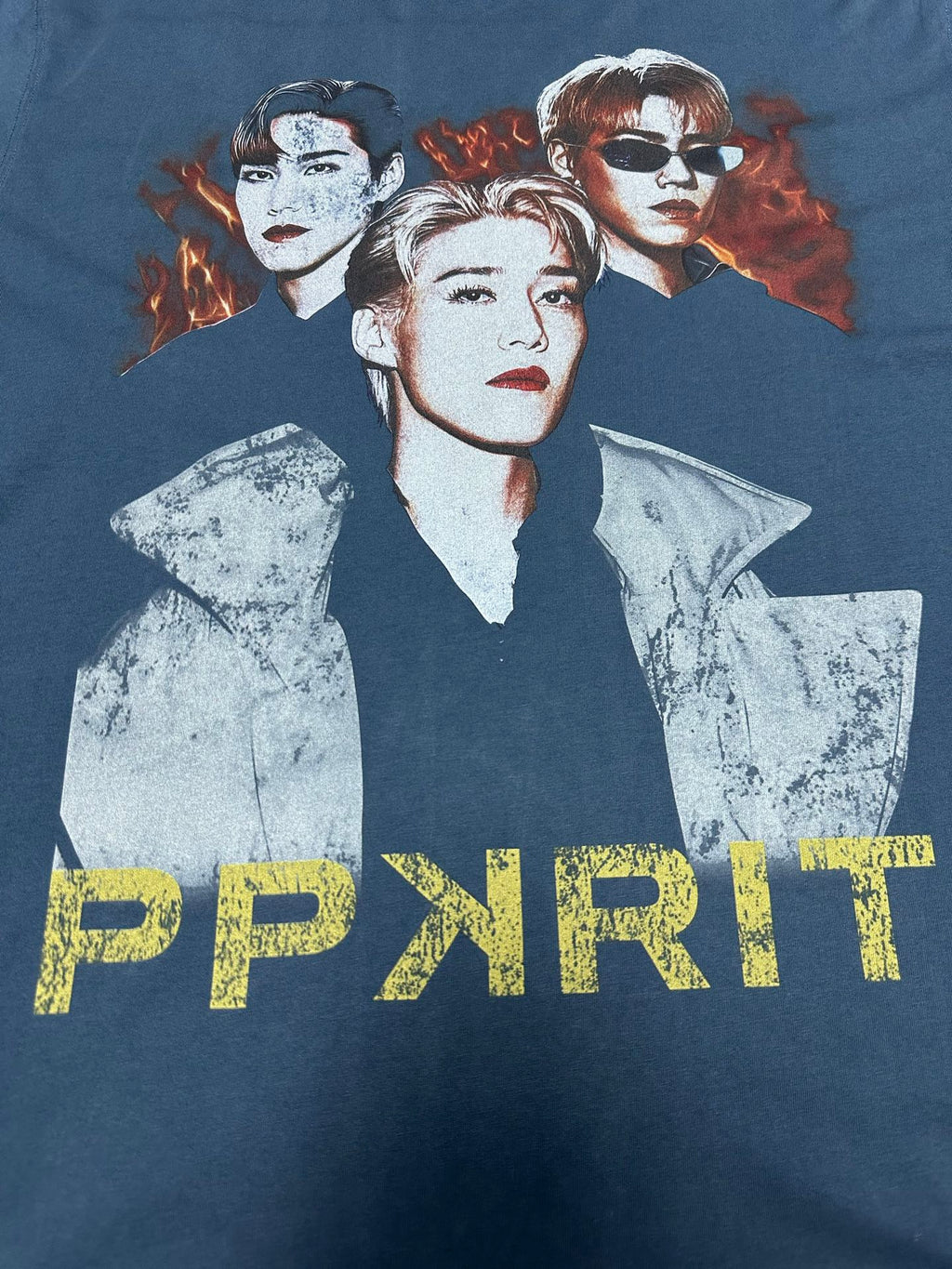 Blue graphic T-shirt with three portrait figures and PPYRIT text at the bottom