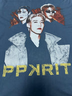 Blue graphic T-shirt with three portrait figures and PPYRIT text at the bottom