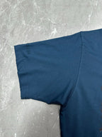 Blue T-shirt sleeve and side seam detail, laid flat