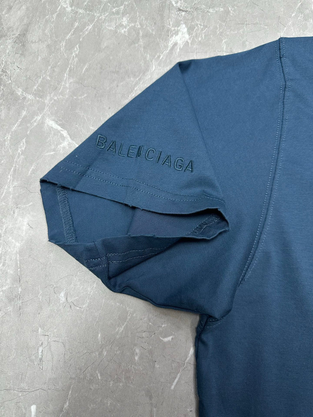 Blue T-shirt with Balenciaga logo on a folded garment label