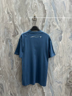 Blue T-shirt with small white logo graphic on the back neckline