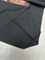 Balenciaga black T-shirt side seam and draped fabric close-up