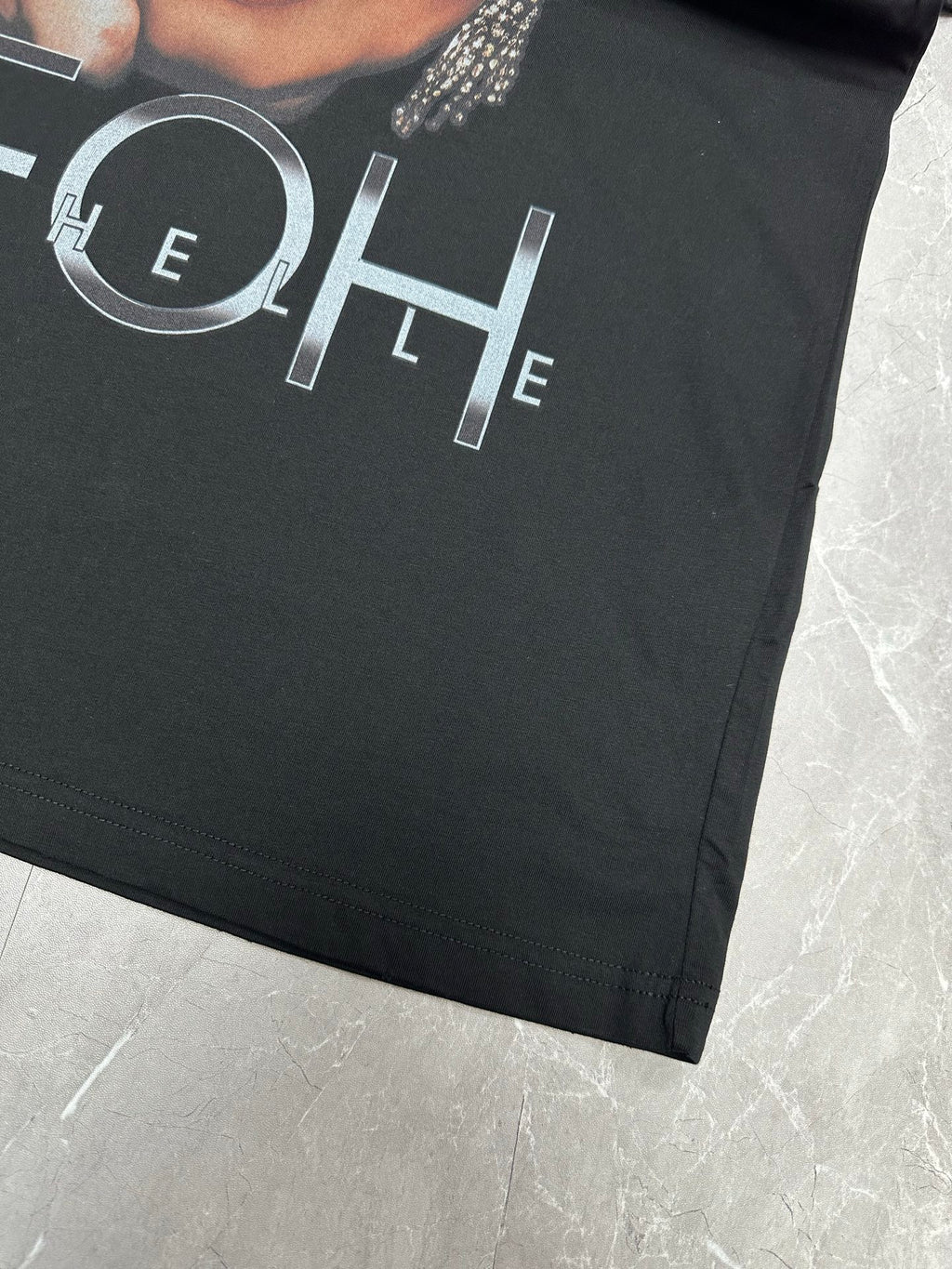 Balenciaga black T-shirt close-up of outlined MYEHEIH lettering