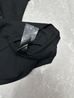 Black short-sleeve T-shirt with care tag on folded collar close-up