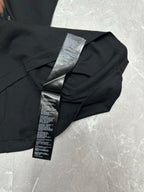 Black short-sleeve T-shirt with printed care label on folded fabric