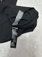 Black short-sleeve T-shirt with care label on collar and neckline