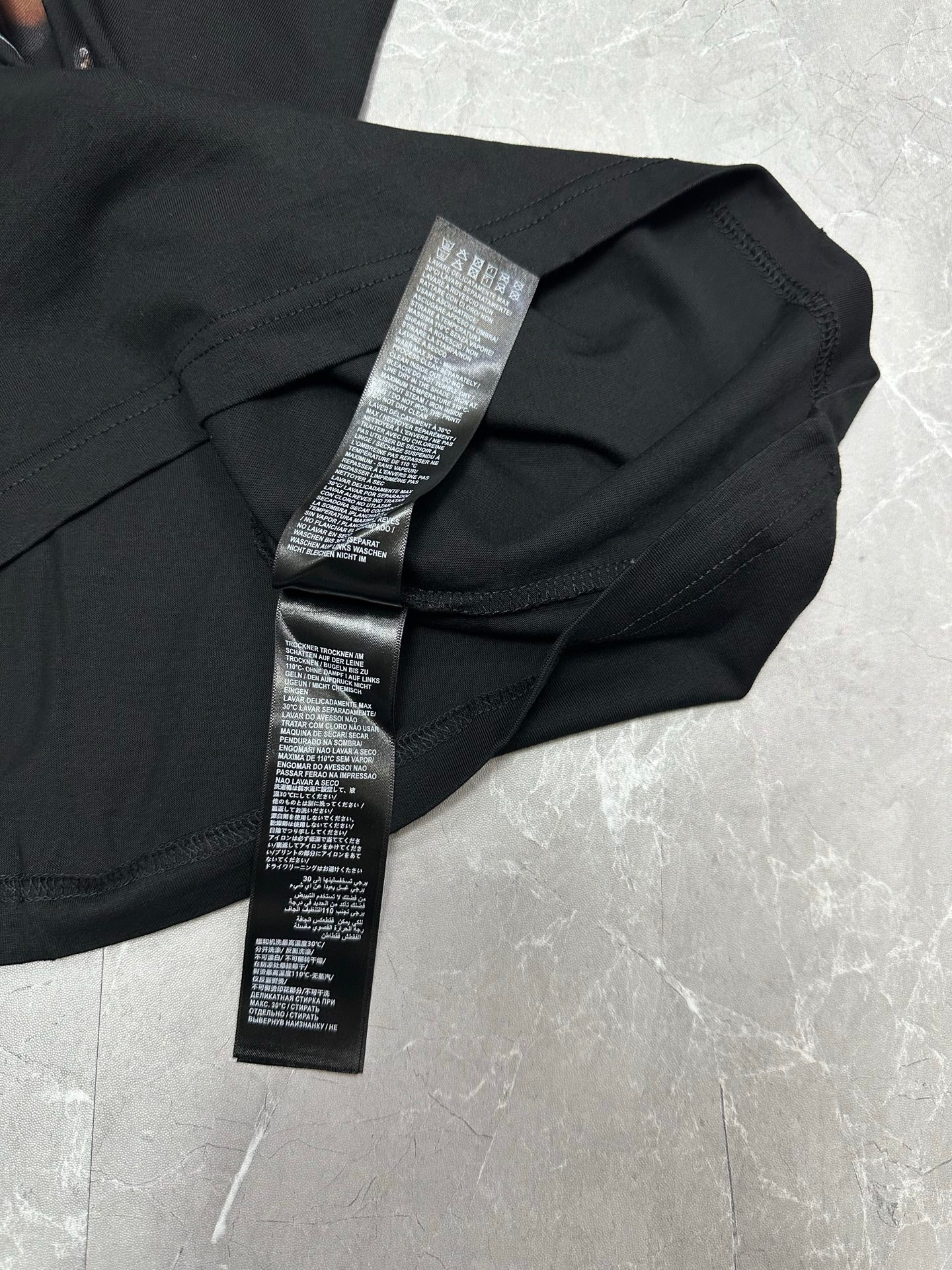 Black short-sleeve T-shirt with care label on collar and neckline