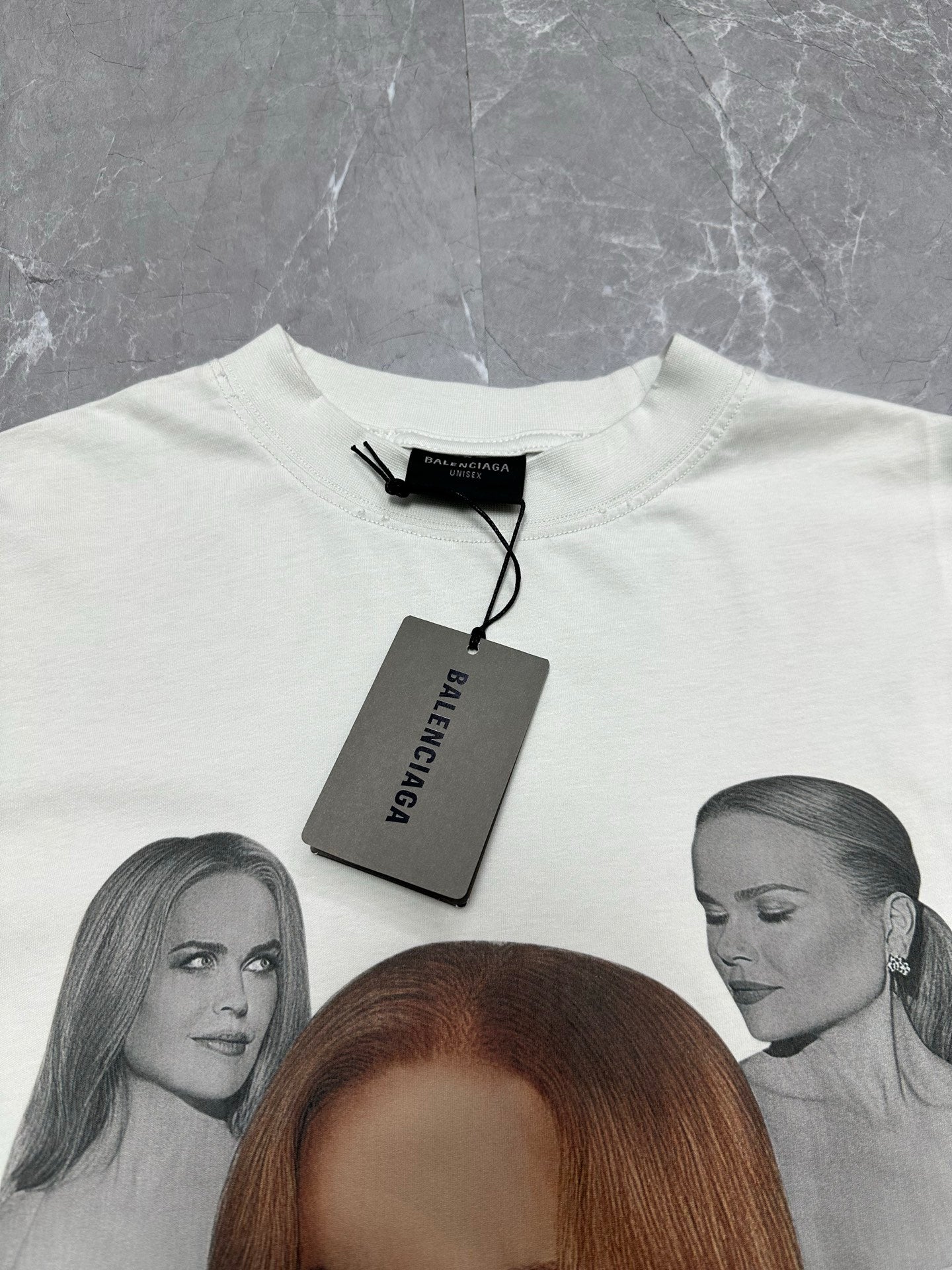 White T-shirt with crew neckline and hanging size tag, featuring portrait graphic