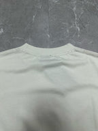 White crewneck T-shirt back with small brand tag at the neckline area