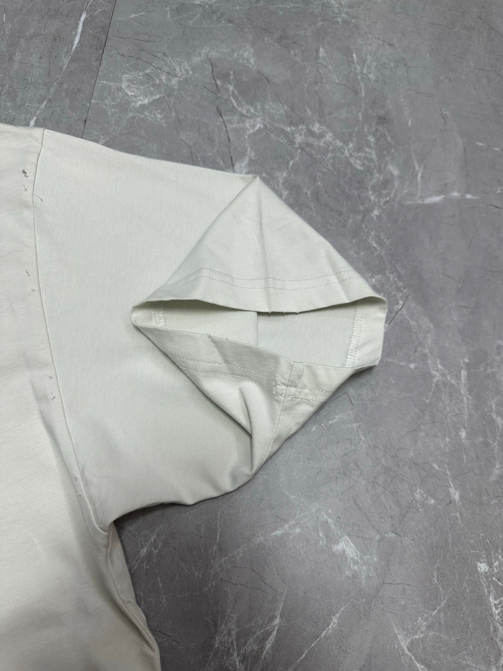 White T-shirt draped showing short sleeve and folded shoulder detail