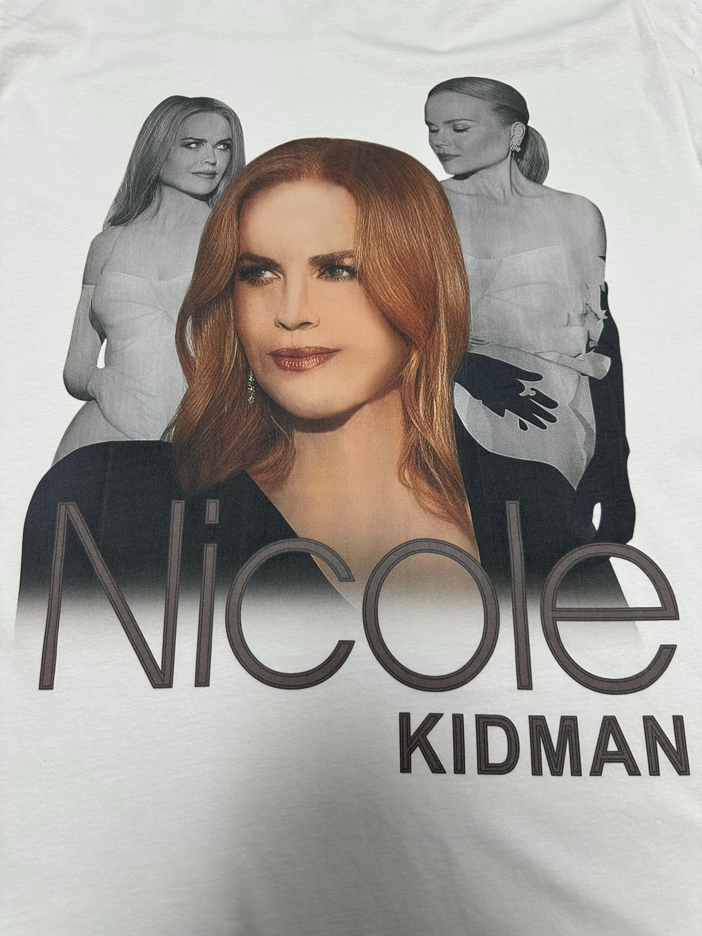 White graphic T-shirt with “Nicole” and “Kidman” text across the front