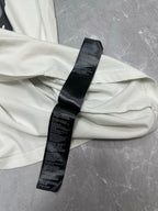 White T-shirt back with black care label and stitched hem detail