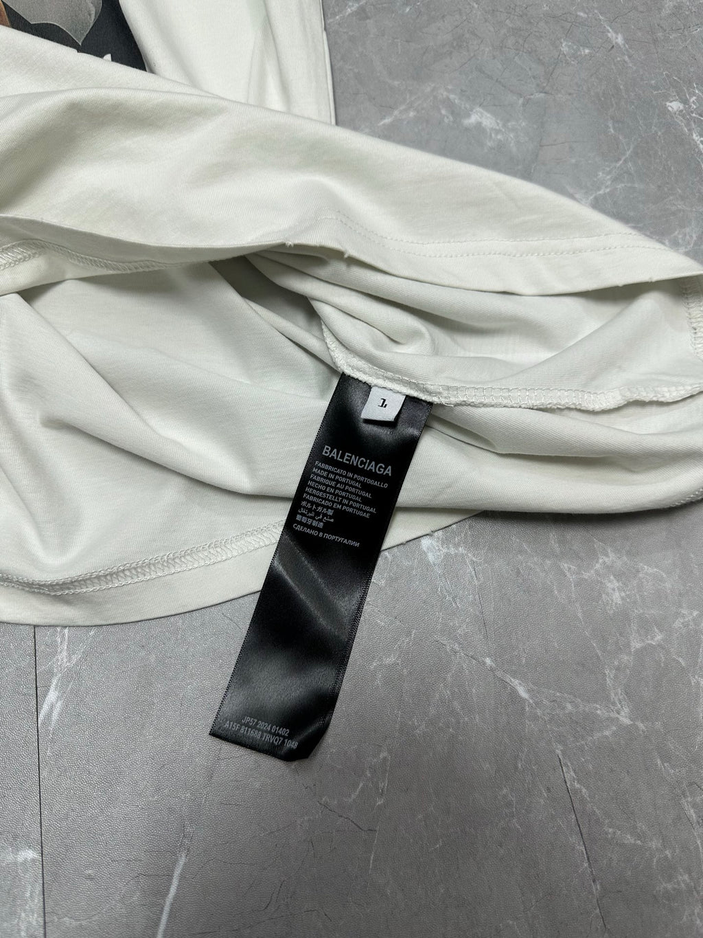 White T-shirt neckline and sleeve with black brand care label