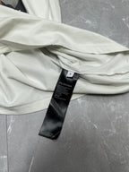 White T-shirt neckline and sleeve with black brand care label