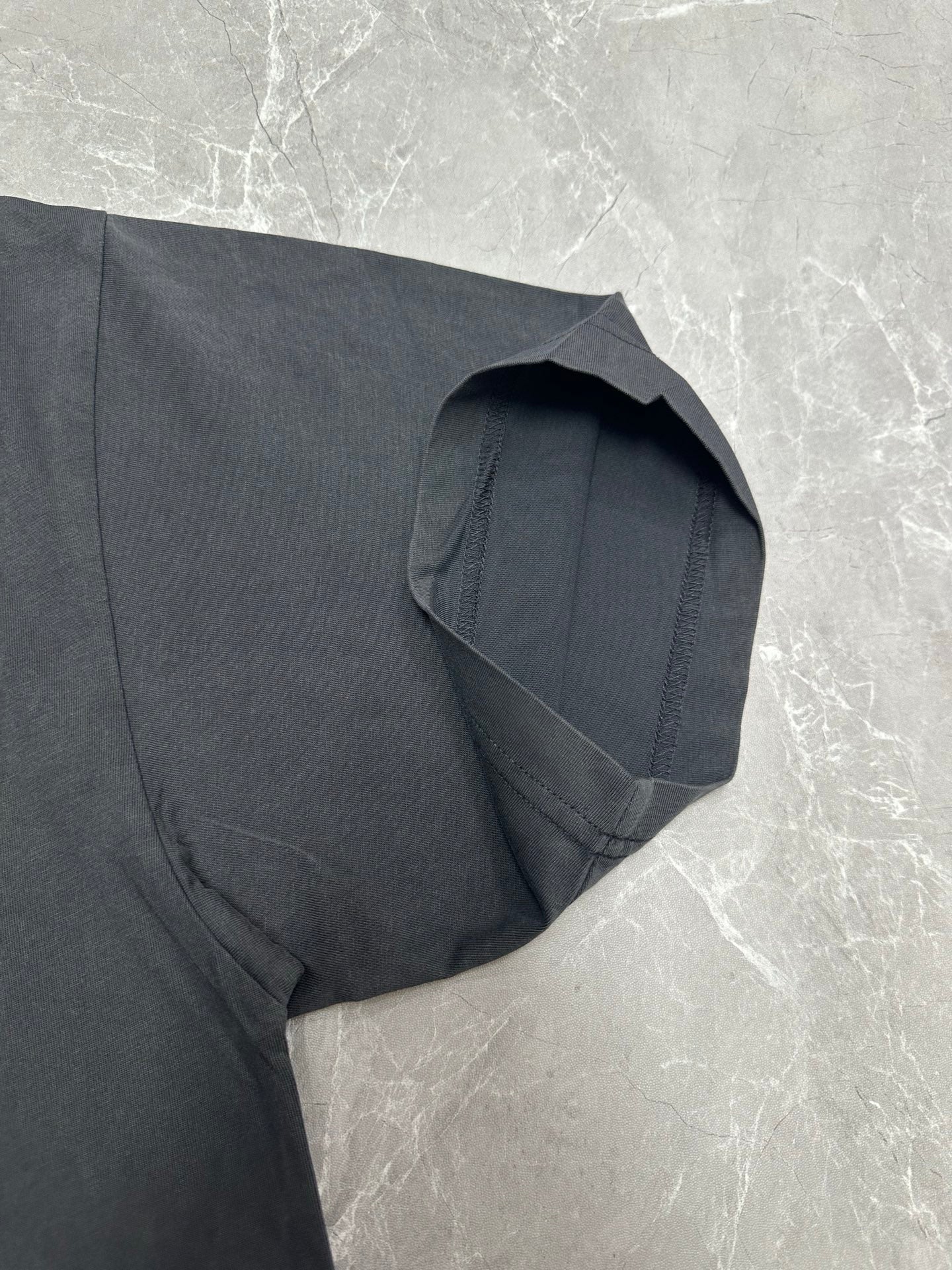 Dark charcoal short-sleeve T-shirt with side seam and folded sleeve detail